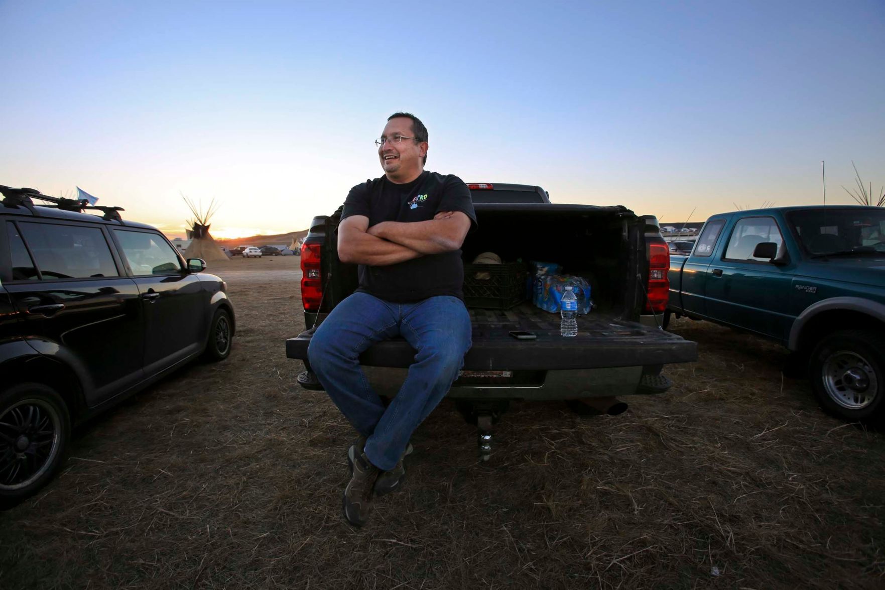 Jerry Thex sits on his truck